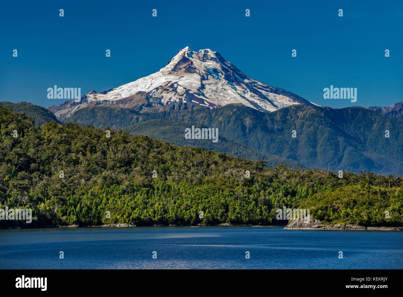 Volcan Maca, Islas Huichas covered with Valdivian temperate rainforest, Ferrovave Channel, near Puerto Aguirre, Patagonia, Chile Stock Photo
