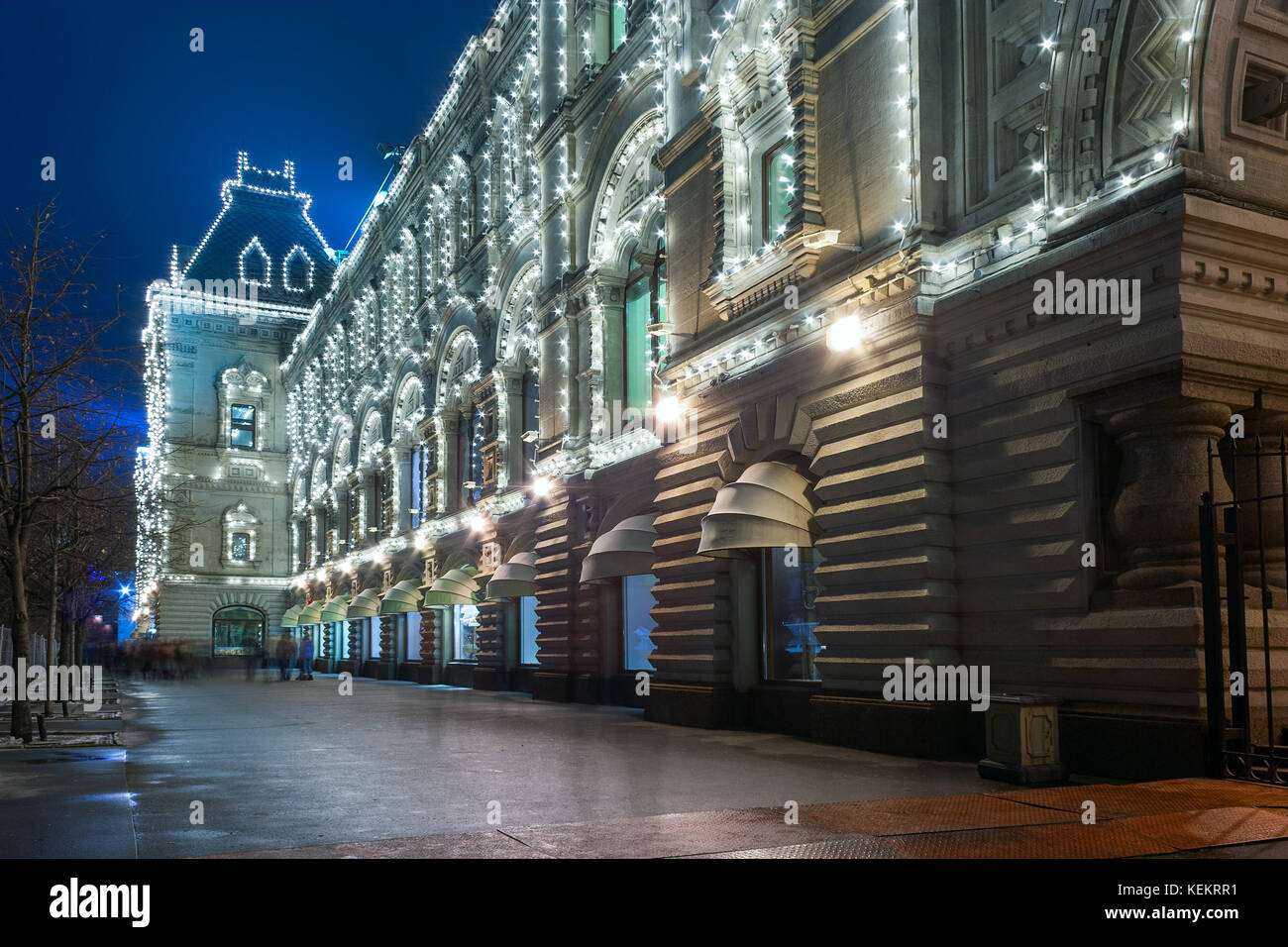 Old russian architecture example: Main Department Store (GUM) at the Red Square in Moscow by winter evening with Christmas illumination with people wa Stock Photo