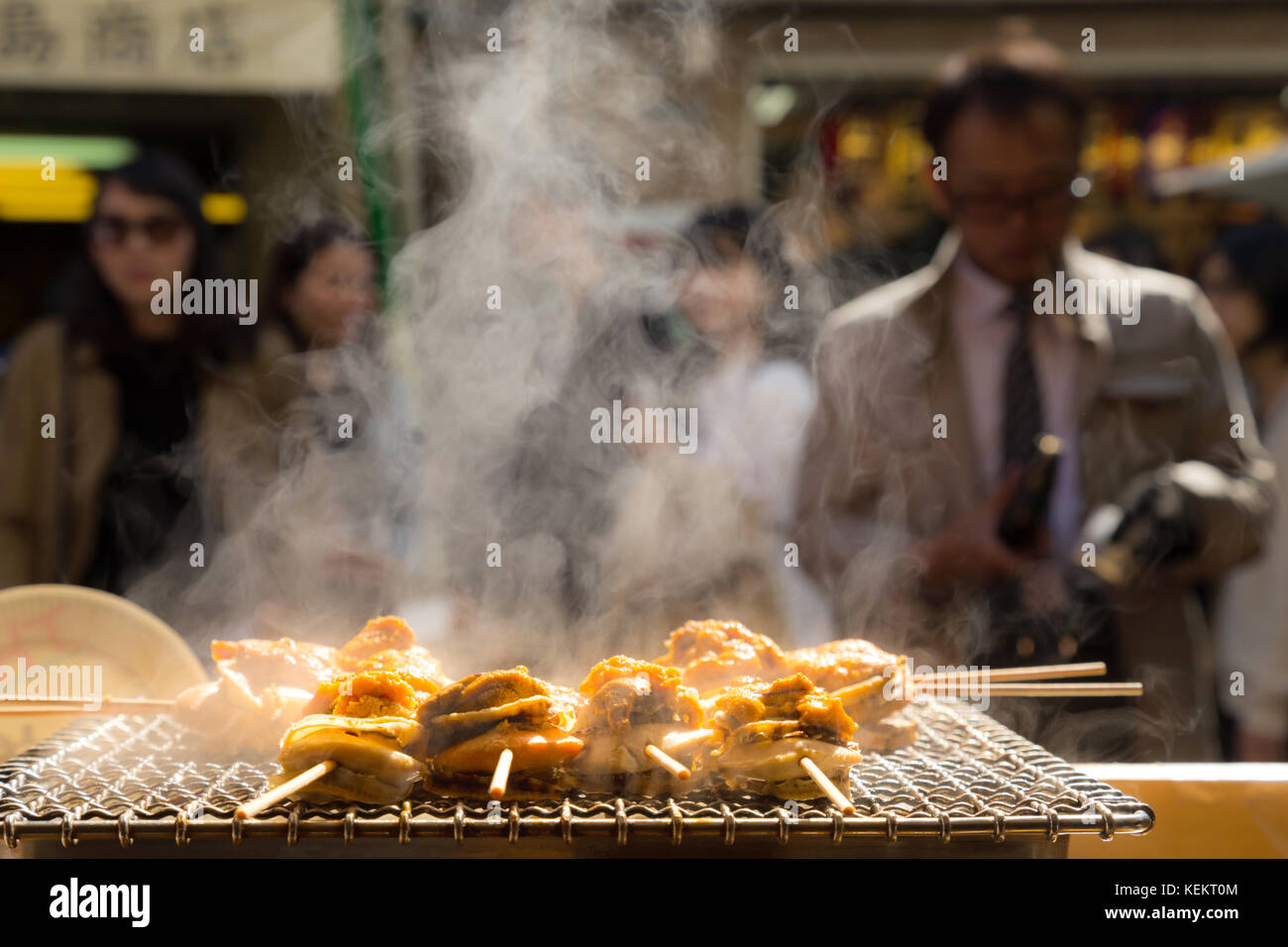 grilled seafood scallop and sea urchin eggs skewer with smoke, japanese