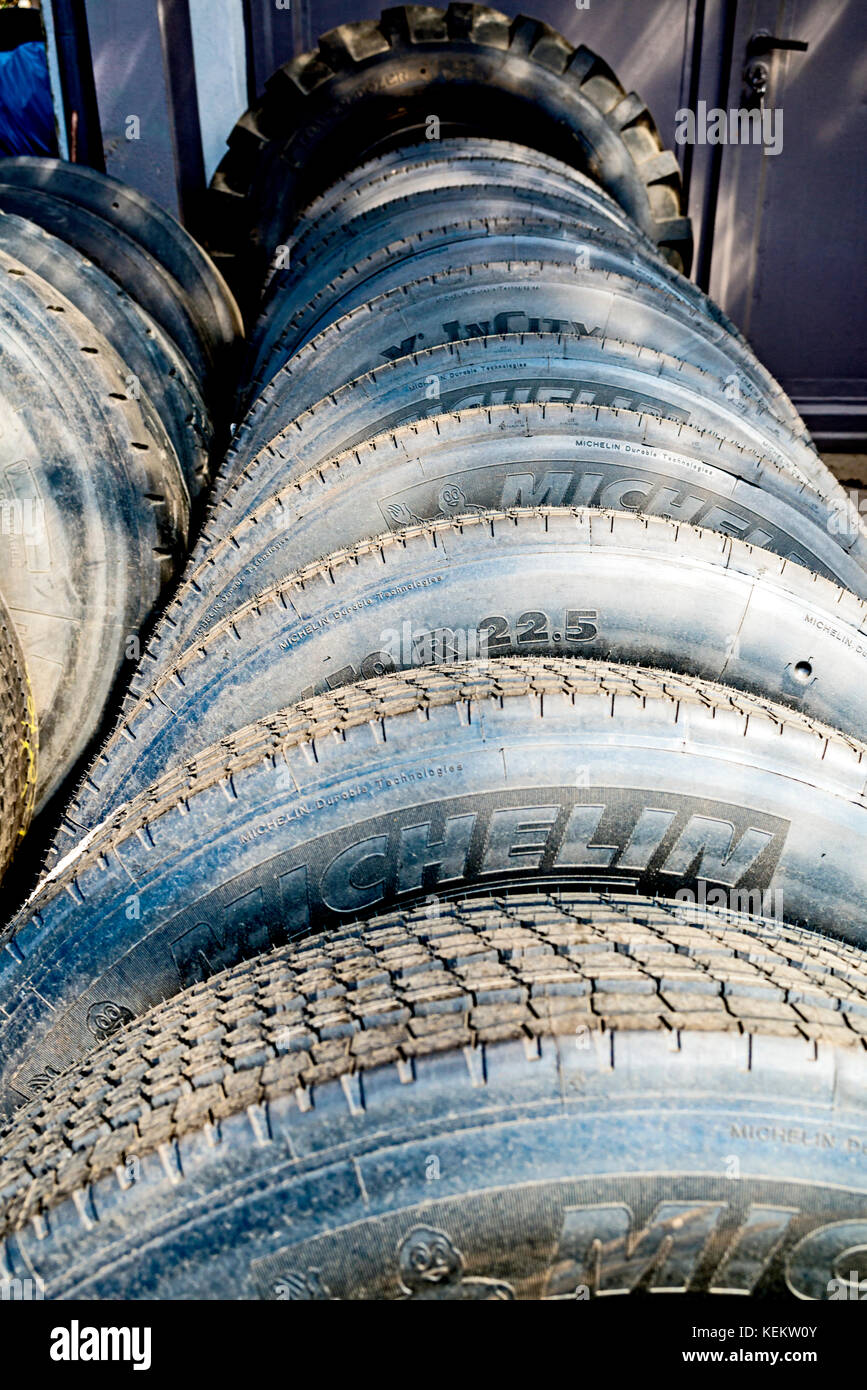 Pile of old Tyres in a shop, Alte Reifen Stock Photo - Alamy