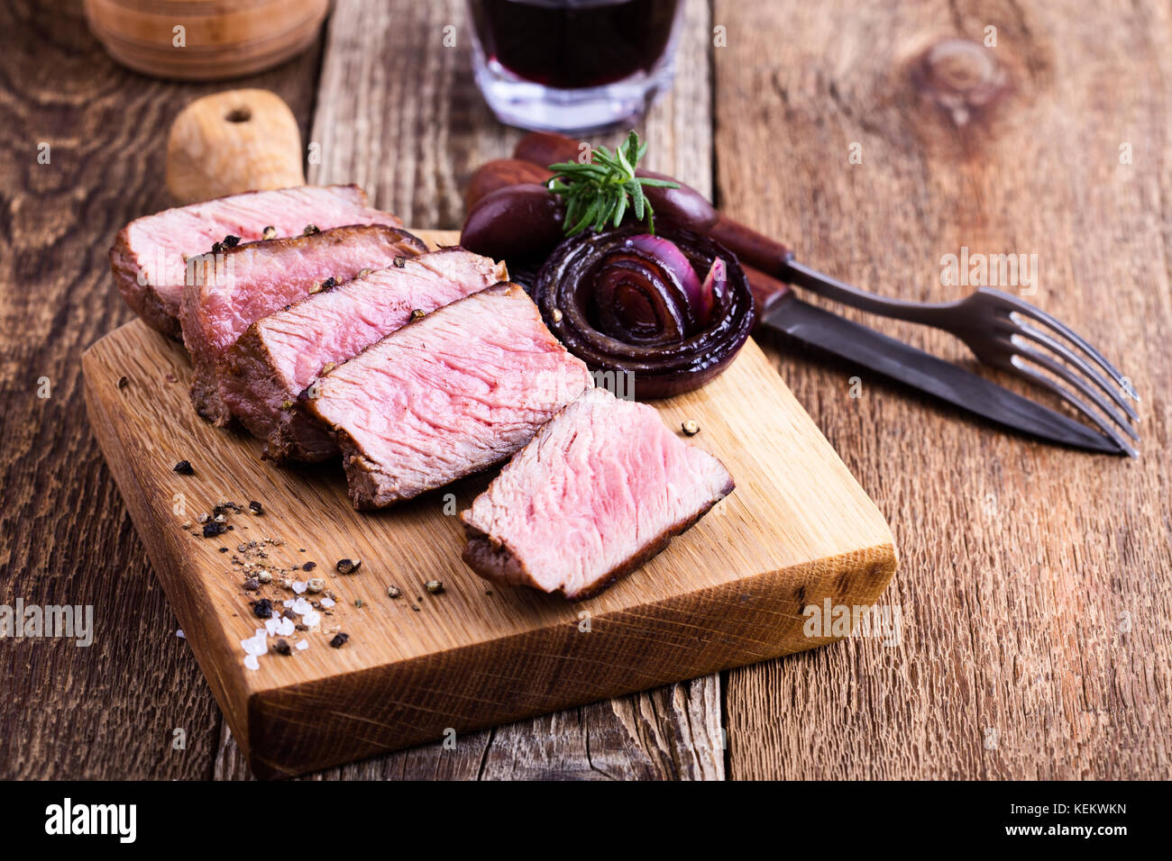 Delicious beef filet mignon served on wooden cutting board with roasted