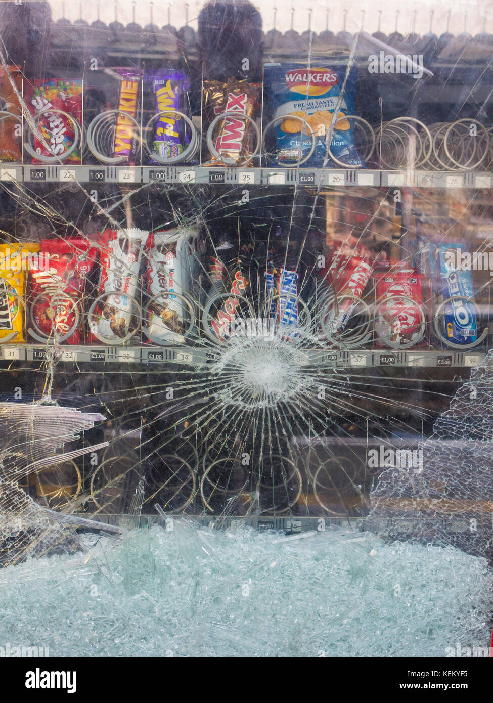 A smashed vending machine on a station platform Stock Photo