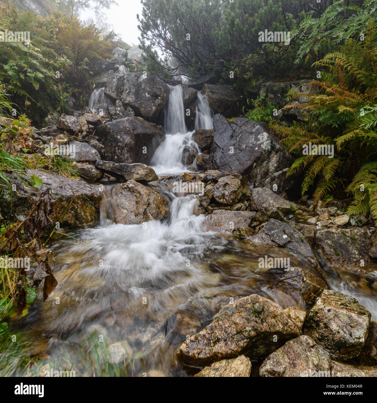 Waterfall from ravine in autumn, long exposure, in mountain river with ...