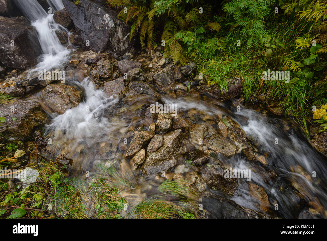 Waterfall from ravine in autumn, long exposure, in mountain river with ...