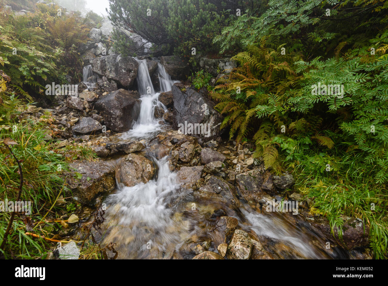 Waterfall from ravine in autumn, long exposure, in mountain river with ...
