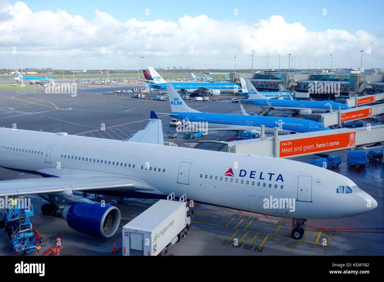 Delta and KLM aircraft on the runway awaiting departure at Amsterdam Schiphol Airport. Stock Photo