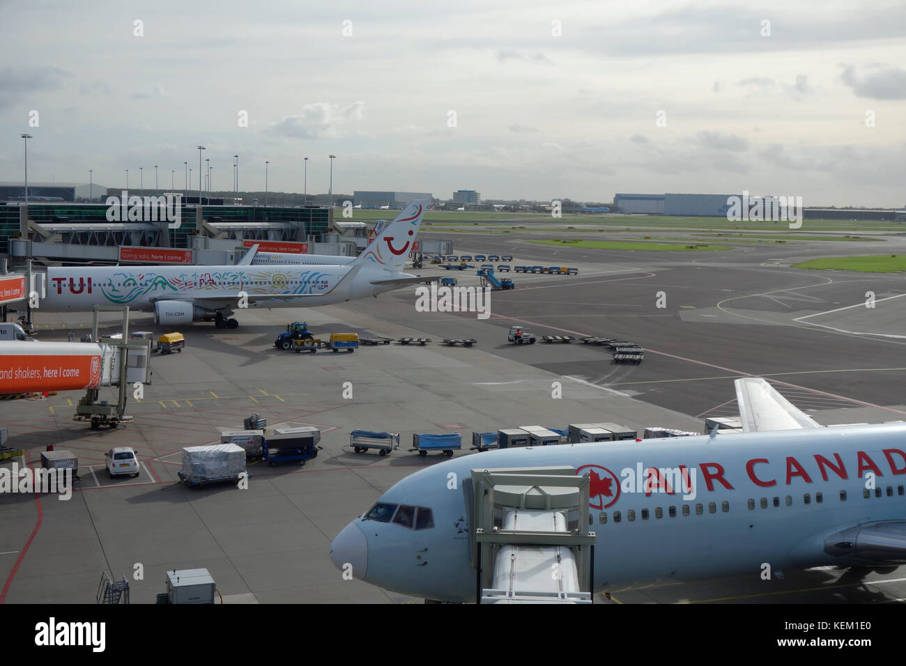 Air Canada and TUI aircraft on the runway awaiting departure at Amsterdam Schiphol Airport Stock Photo