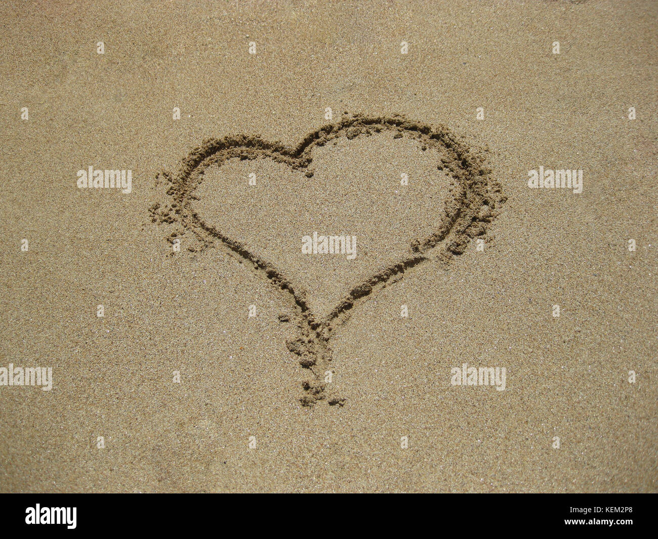 the heart on sand drawn by hand the person Stock Photo - Alamy