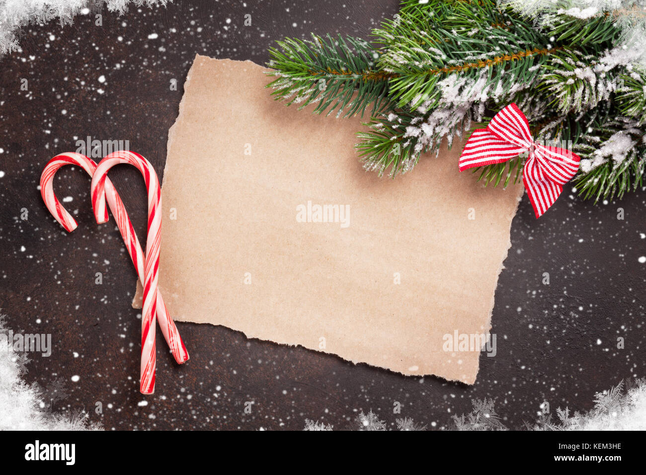 Piece of paper for christmas wishes, candy canes and snow xmas tree ...