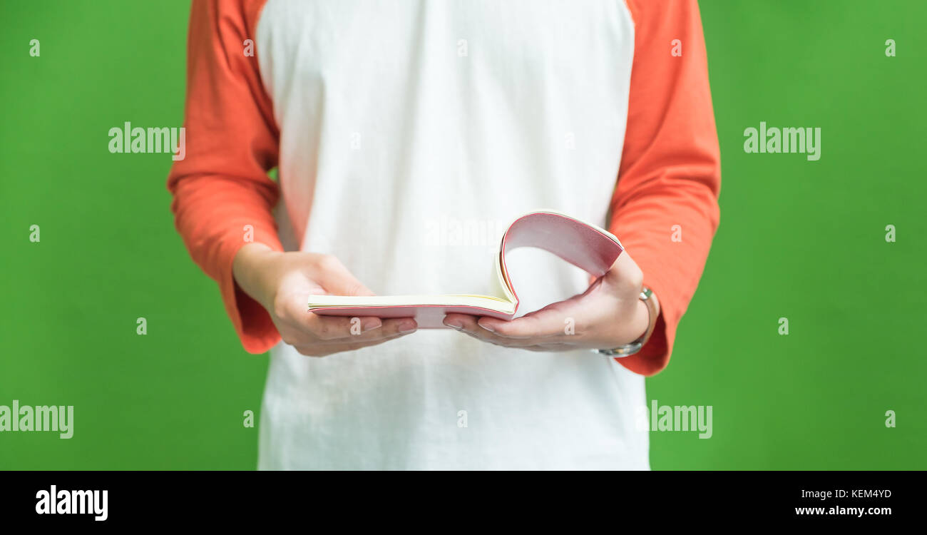 Man wear casual cloth open book at green background,Educaton concept Stock Photo