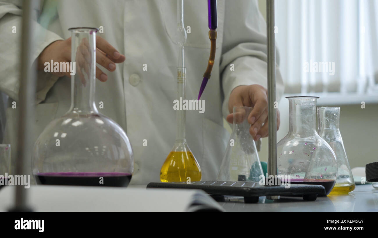 Lab technician doing experiment in lab. Male medical or scientific