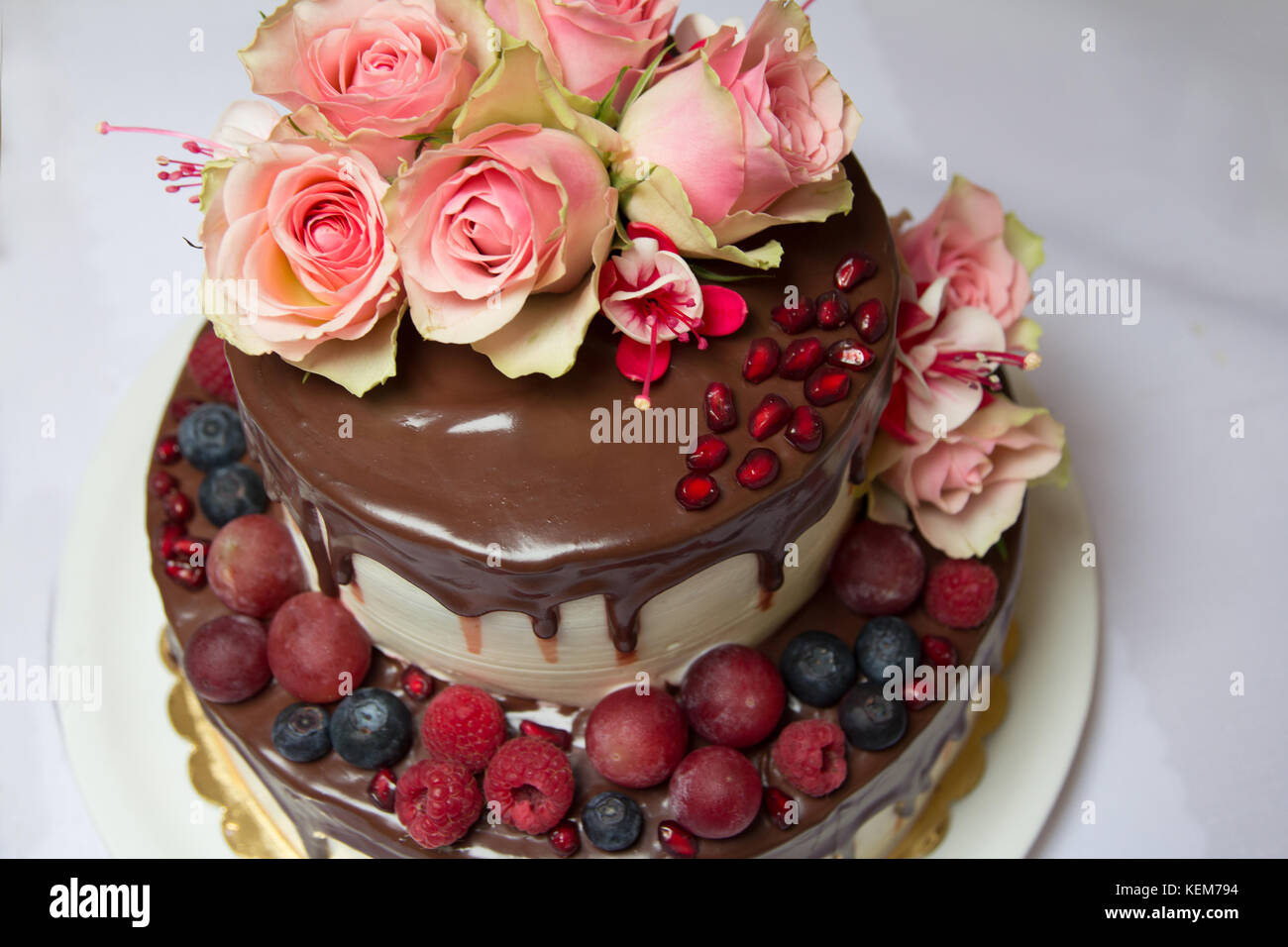 cake with chockolate streaks, berries and flowers Stock Photo