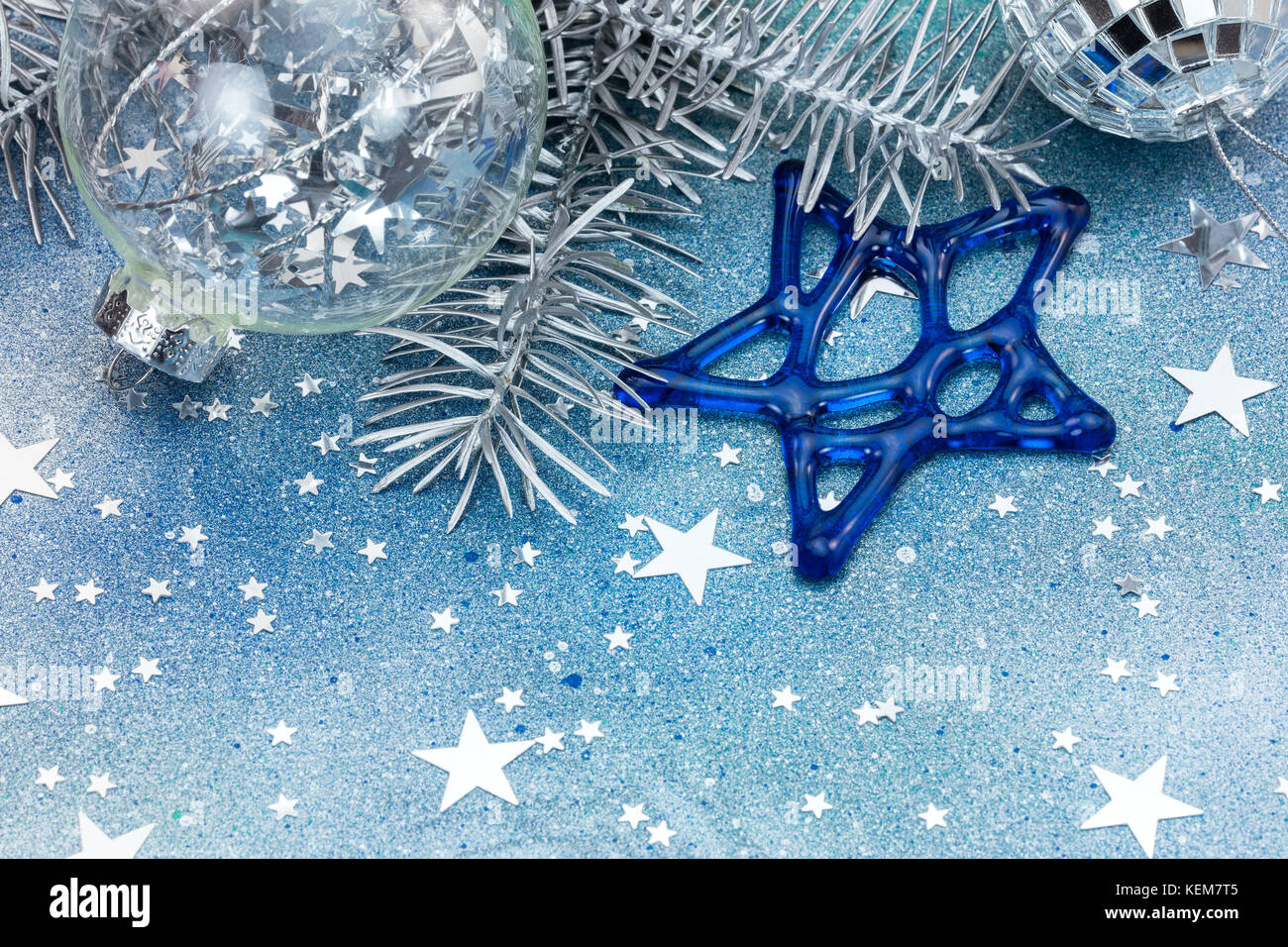 silver christmas tree decorations, glass balls and stars on blue ...