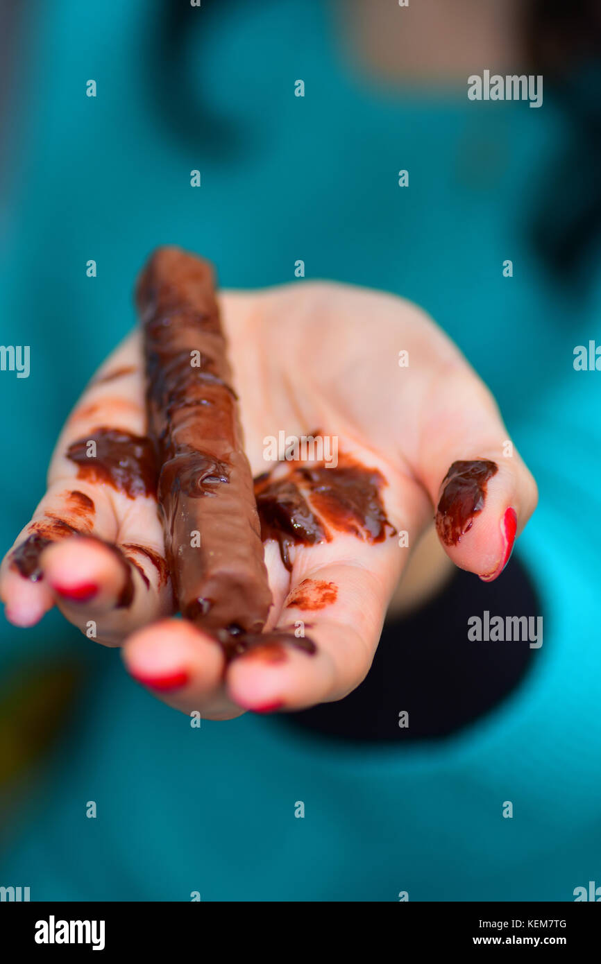 Chocolate bar melting in hand Stock Photo