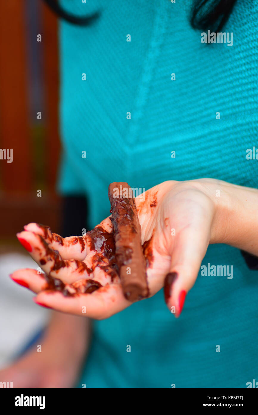 Chocolate bar melting in hand Stock Photo