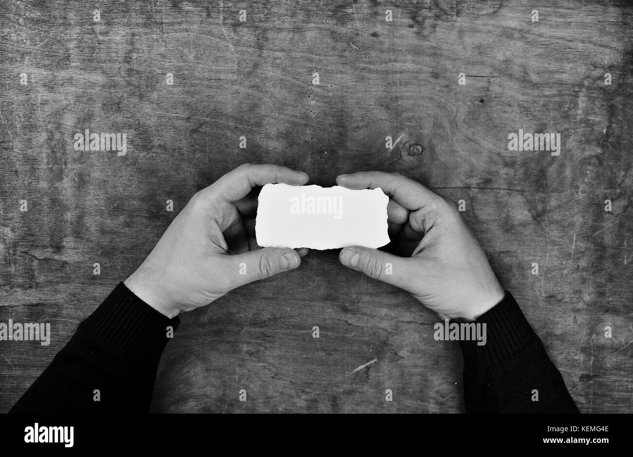 monochrome photo male hands holding a white blank sheet of paper Stock ...