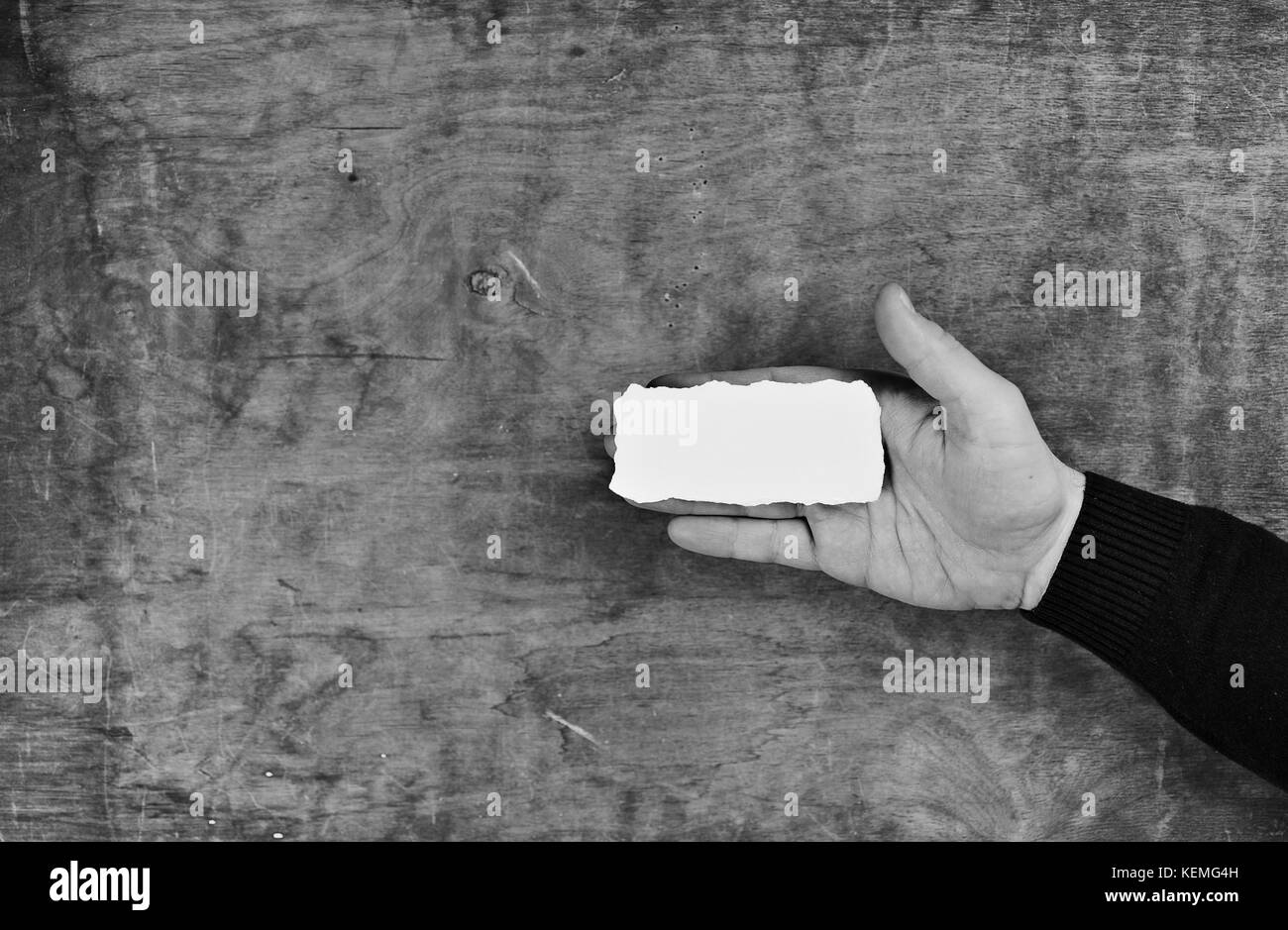 monochrome photo male hands holding a white blank sheet of paper Stock ...
