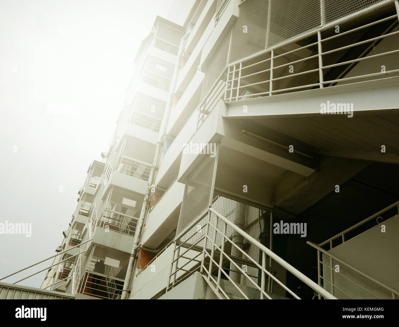 fire escape stairs with sunlight of outside buildings Stock Photo