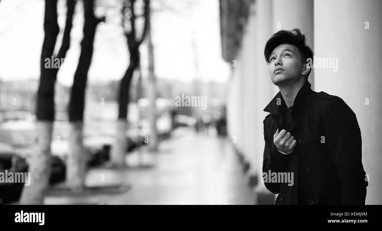 Black White photo of Asian young man outdoors posing Stock Photo - Alamy