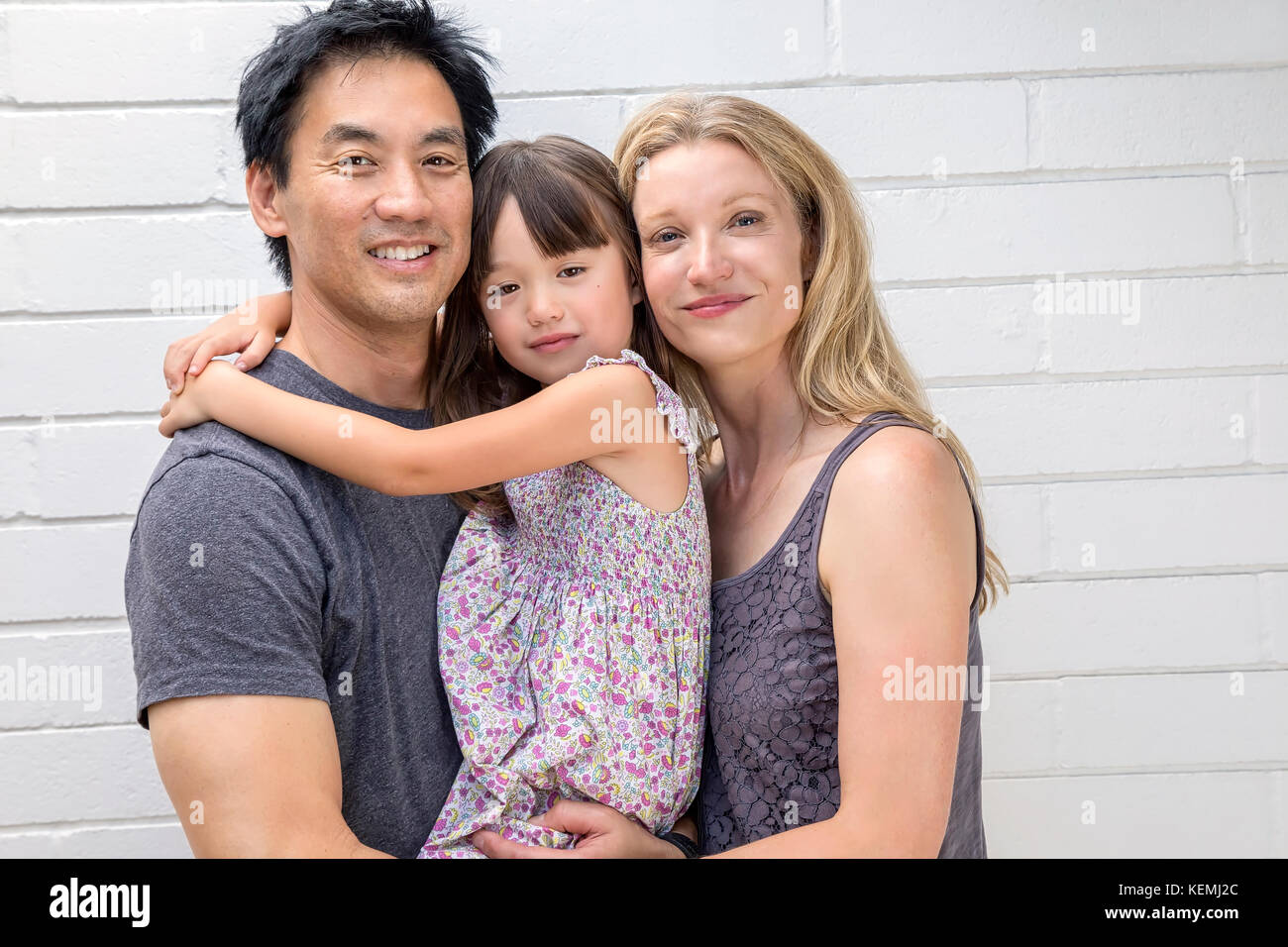 Parents holding their five year old daughter Stock Photo