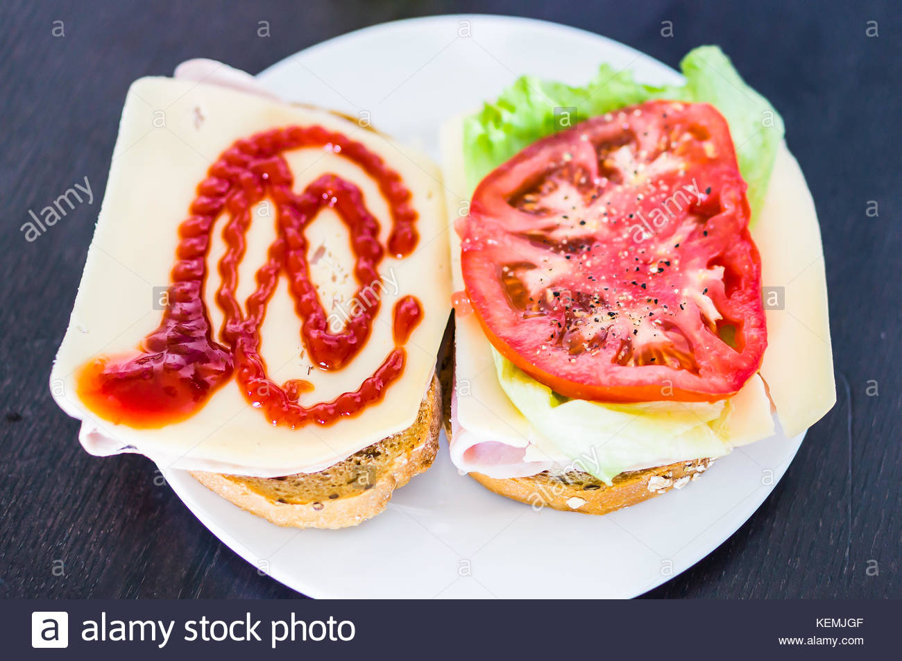Cheese And Ham On Two Slices Of Bread Topped With Tomato And