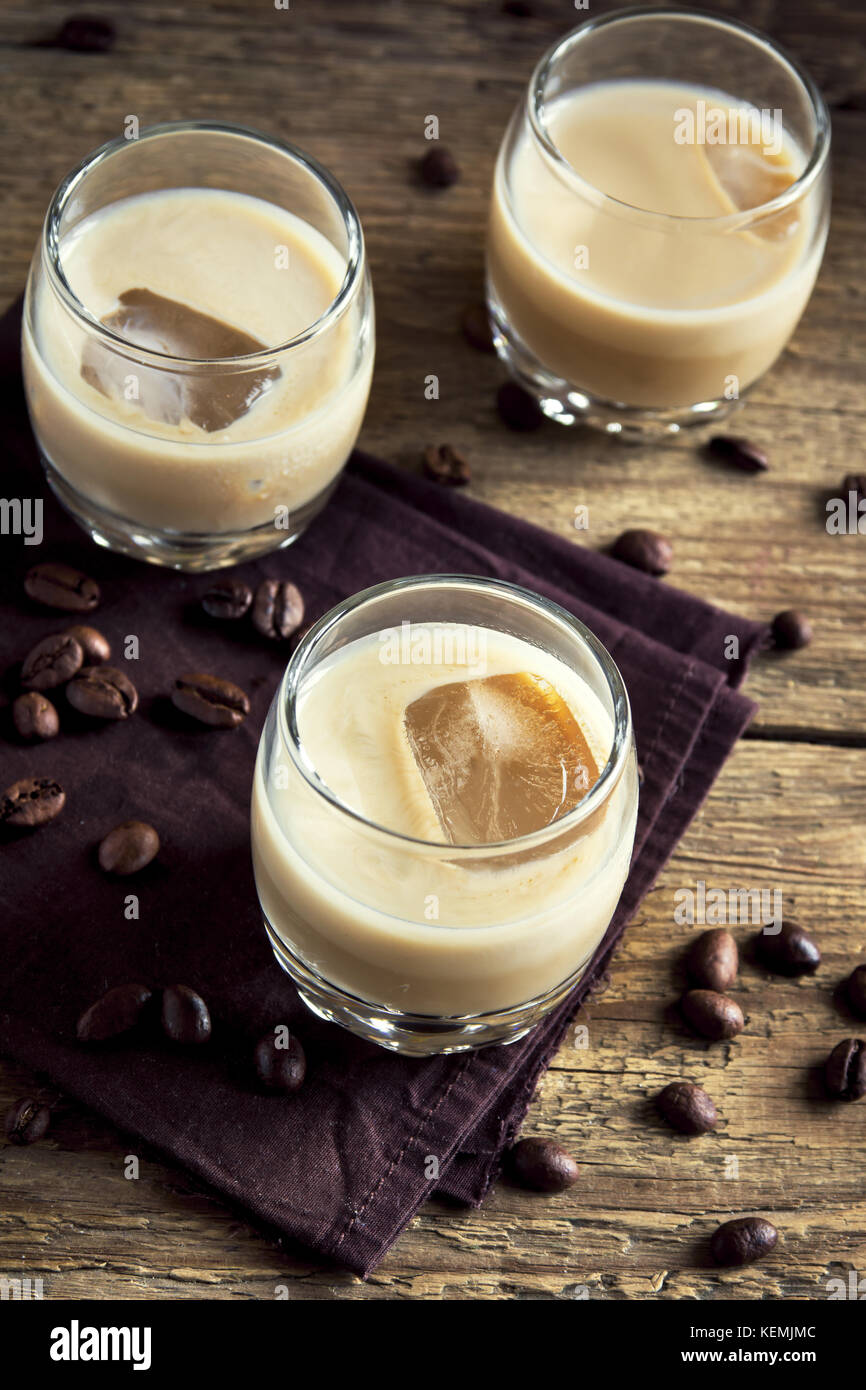 Irish cream coffee liqueur with ice, chocolate candies and coffee beans