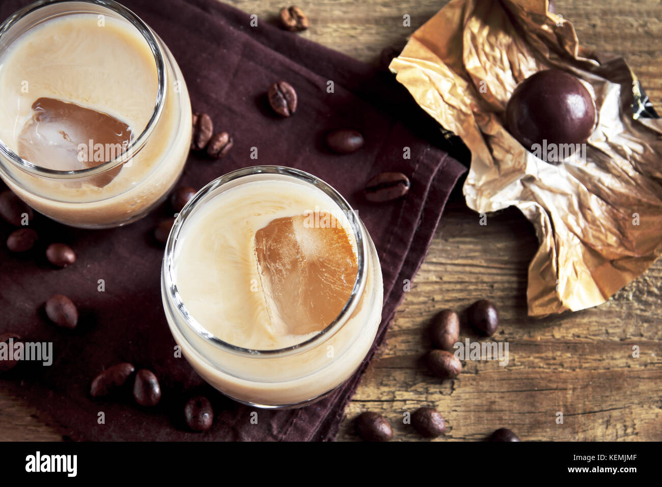 Irish cream coffee liqueur with ice, chocolate candies and coffee beans
