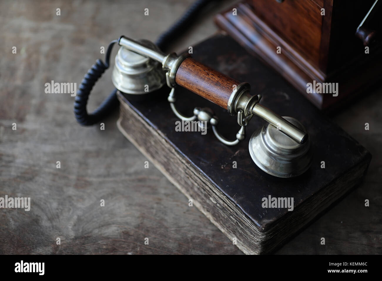 Old telephone and retro book on a wood Stock Photo Alamy