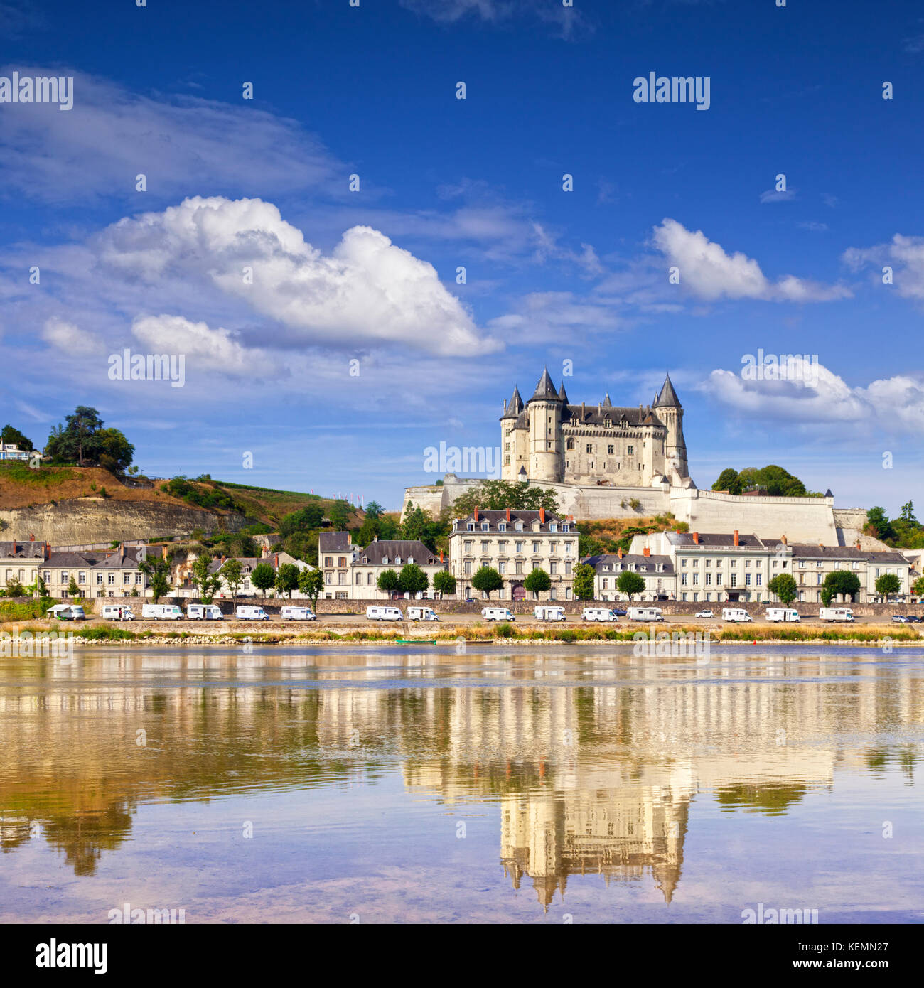 Saumur on the banks of the Loire River, Loire Valley, France. A long row of camper vans can be seen parked below the chateau. Stock Photo