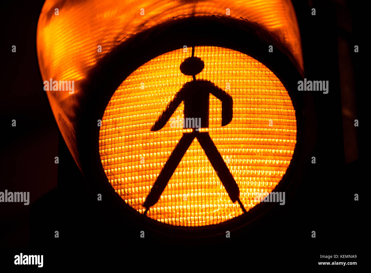 Orange traffic light with icon of walking pedestrian Stock Photo