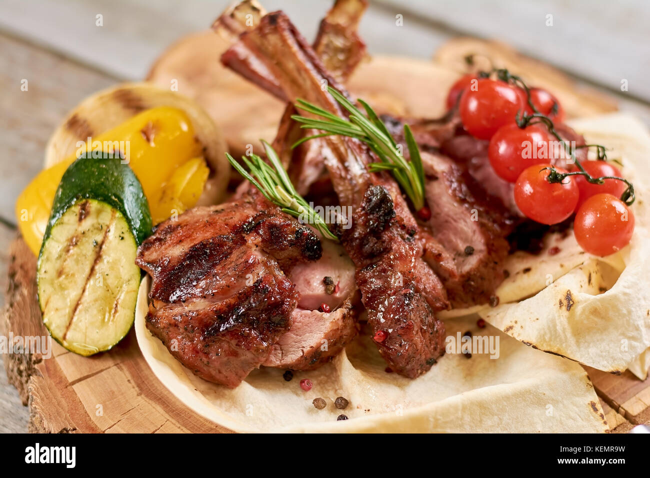 Roasted calf ribs with grilled vegetables. Juicy calf ribs with cherry ...