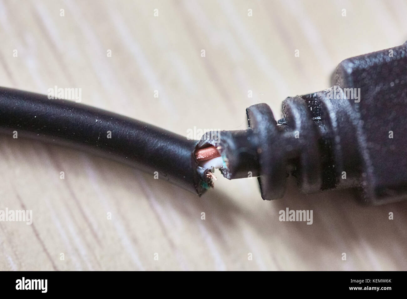 Broken usb cable on a wooden table Stock Photo Alamy