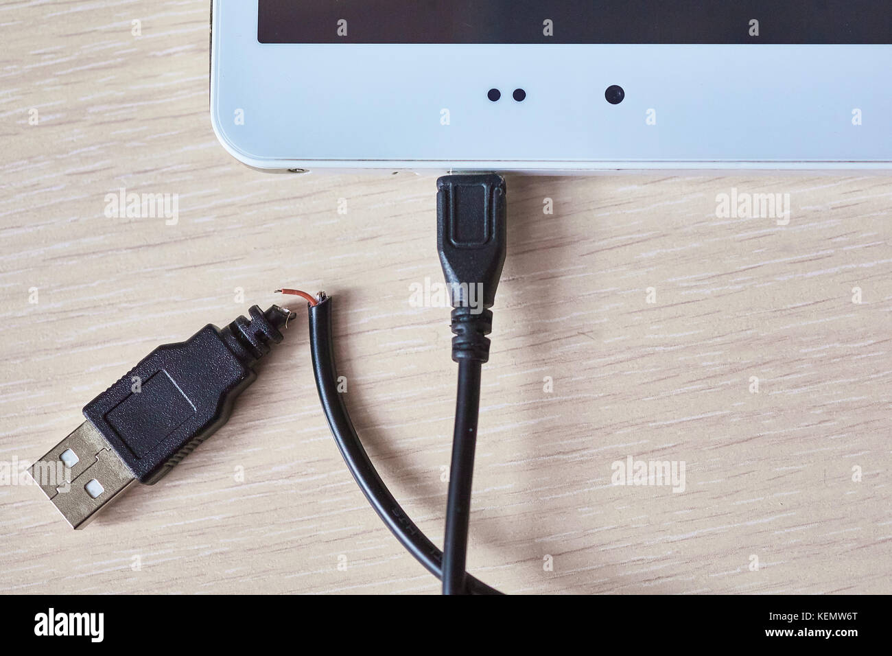 Broken usb cable on a wooden table Stock Photo Alamy