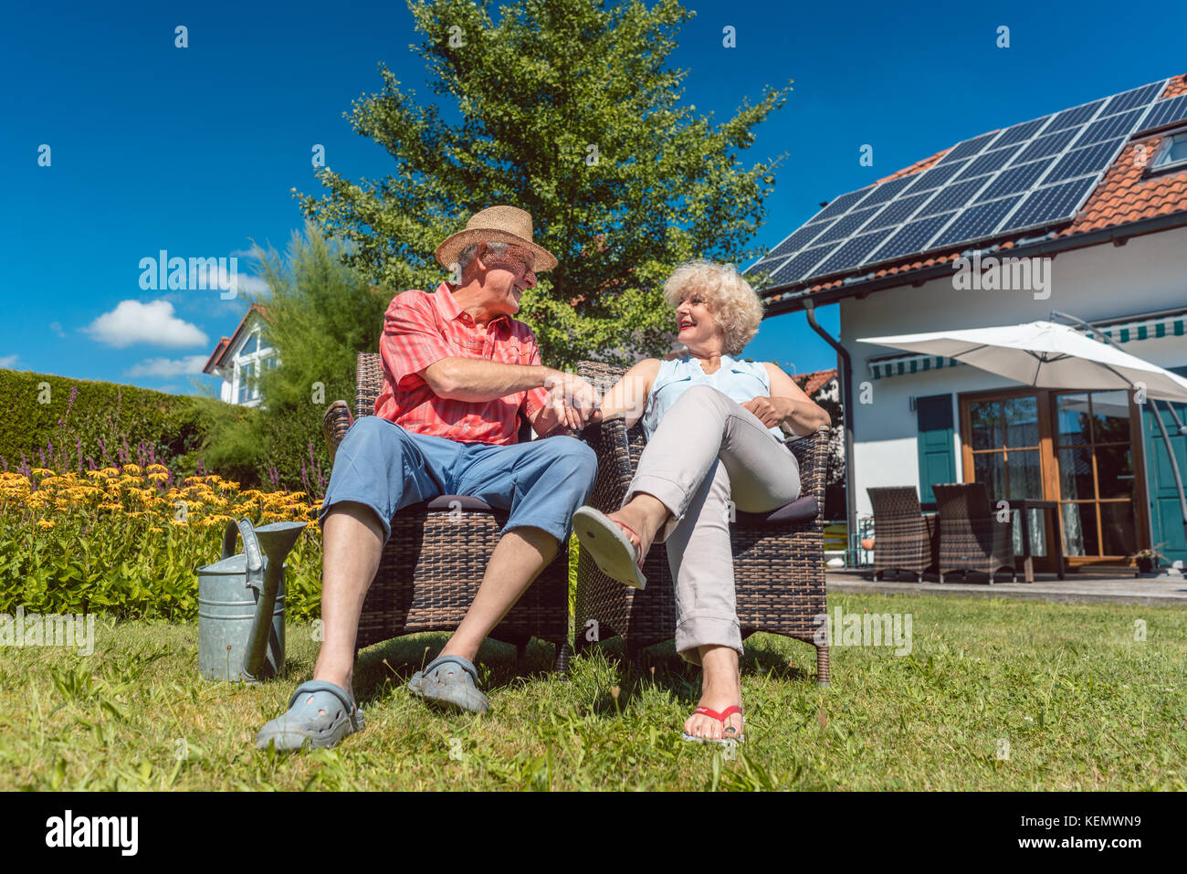 Happy senior couple in love relaxing together in the garden in a Stock ...