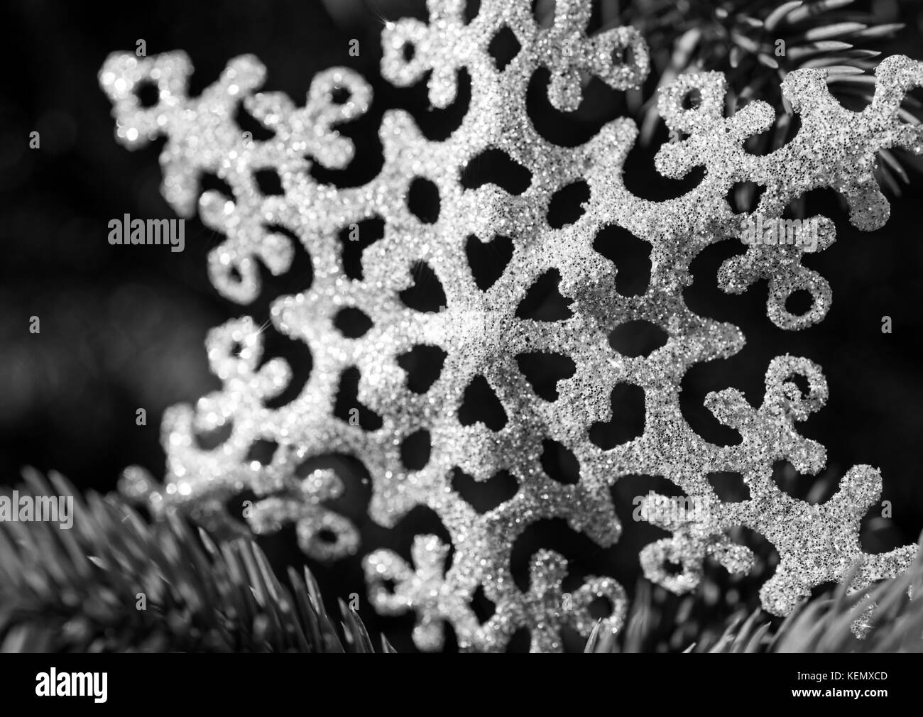 Glitter snowflake Christmas decoration on a tree Stock Photo