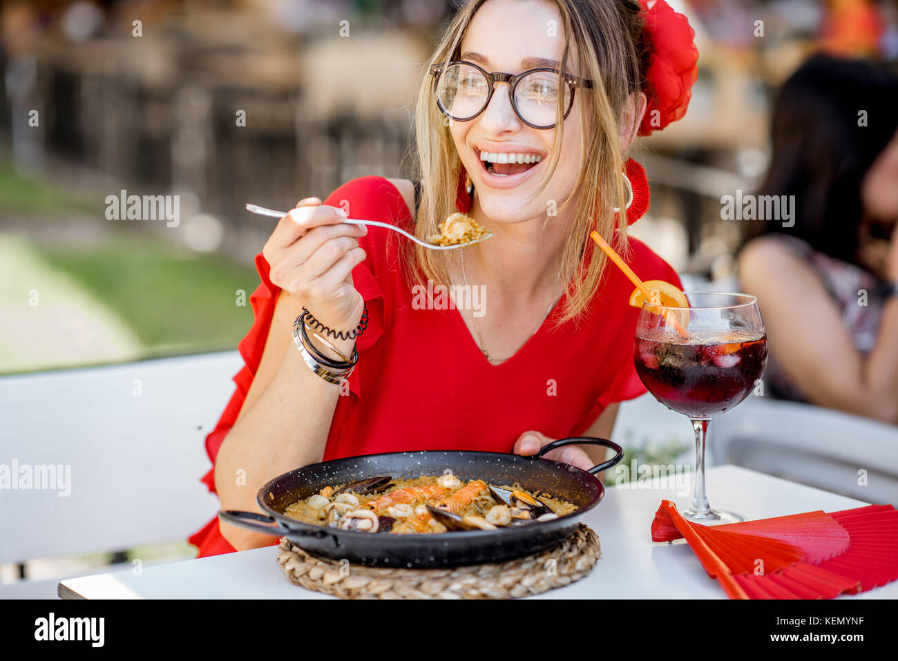 Woman eating Paella dish at the restaurant Stock Photo Alamy