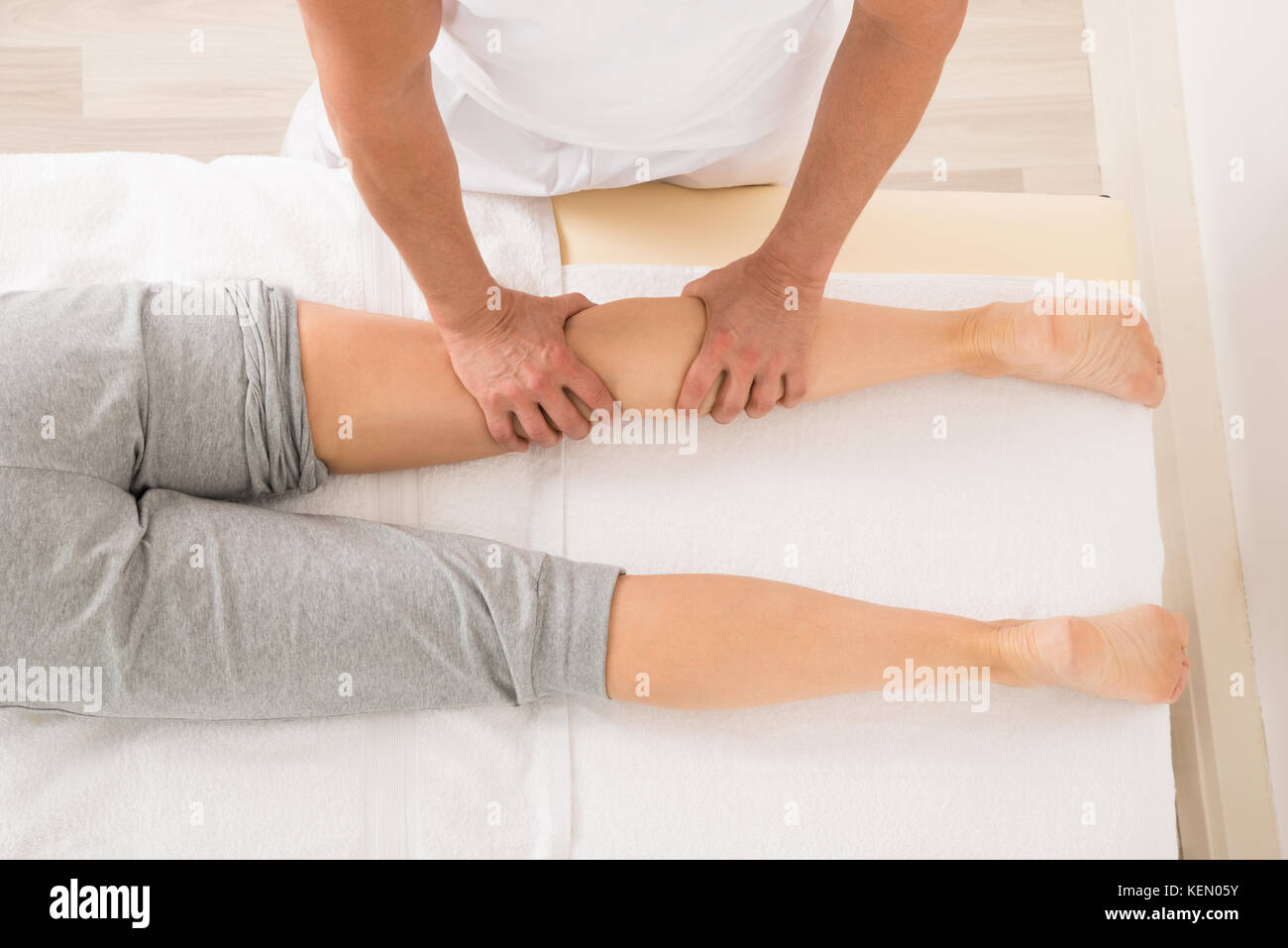 High Angle View Of Therapist Giving Leg Massage In Spa Stock Photo