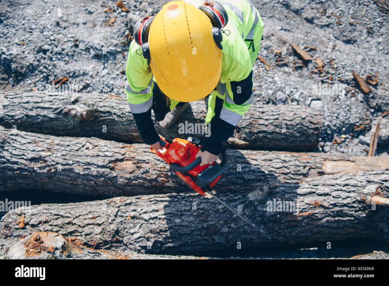 Woman operating chainsaw while wearing safety gear Stock Photo Alamy