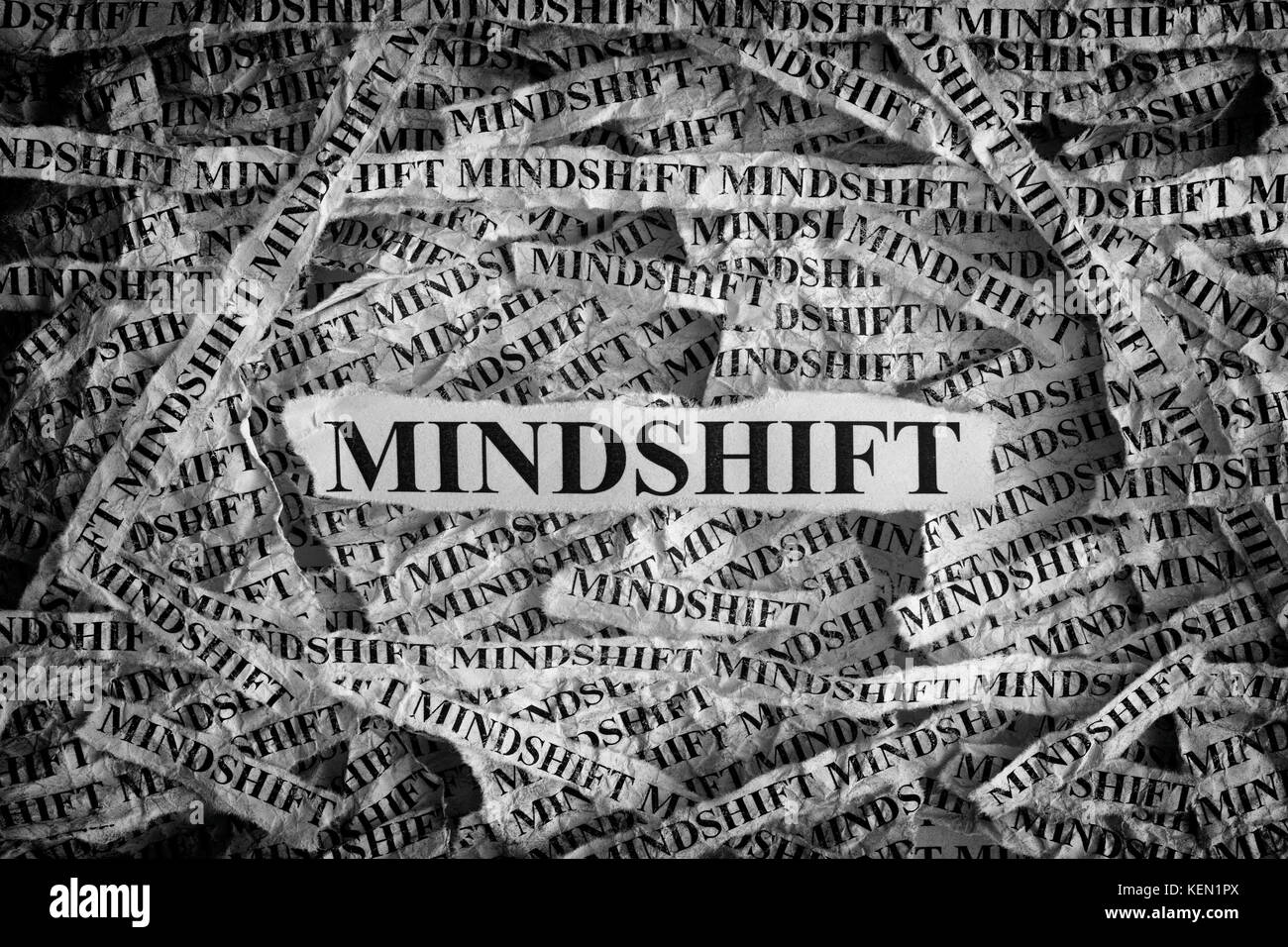 Mindshift. Torn pieces of paper with word Mindshift. Concept Image. Black and White. Closeup. Stock Photo