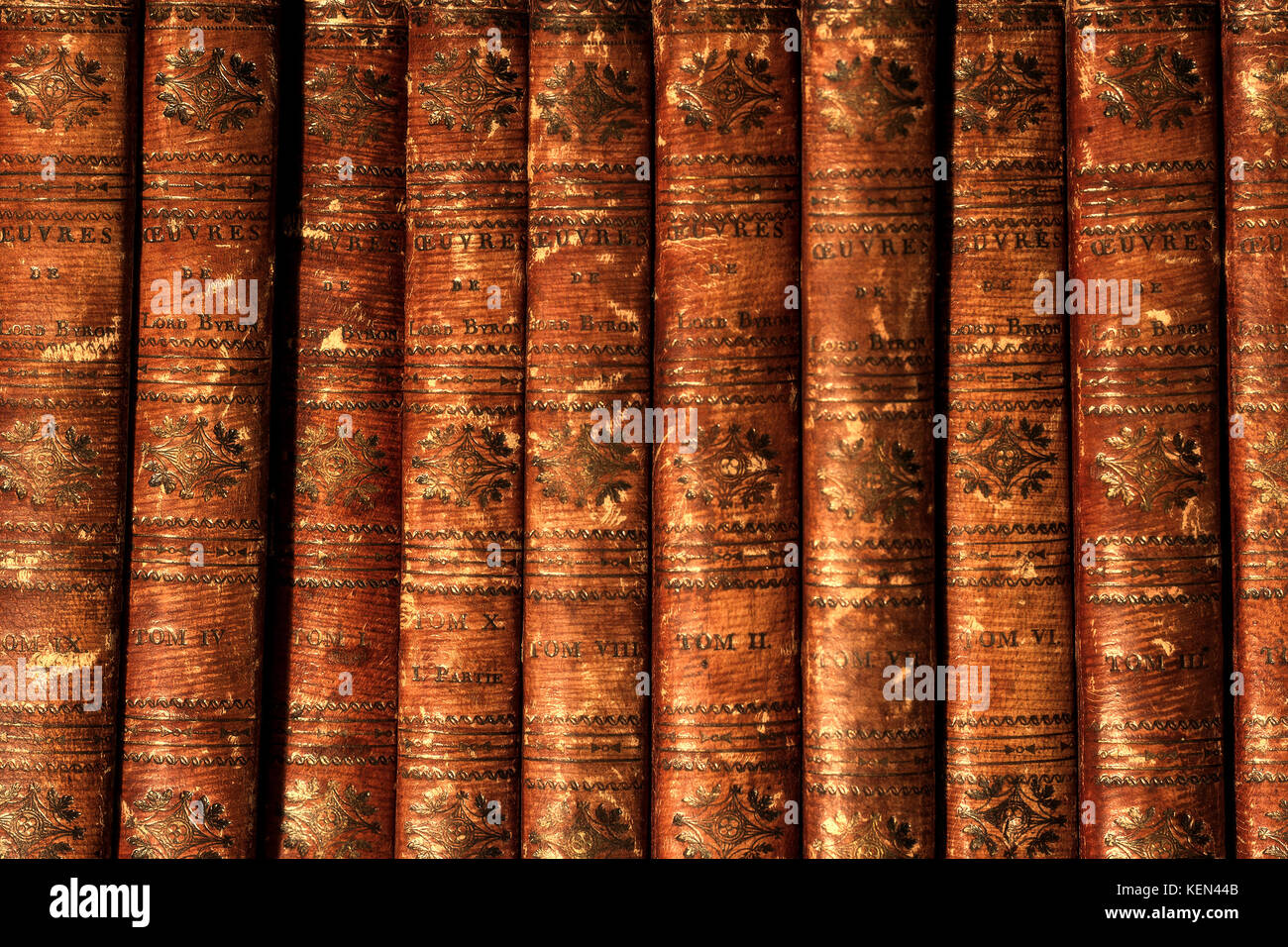 Antique vintage old retro worn grunge brown books by Lord Byron in row on bookshelf. Stock Photo