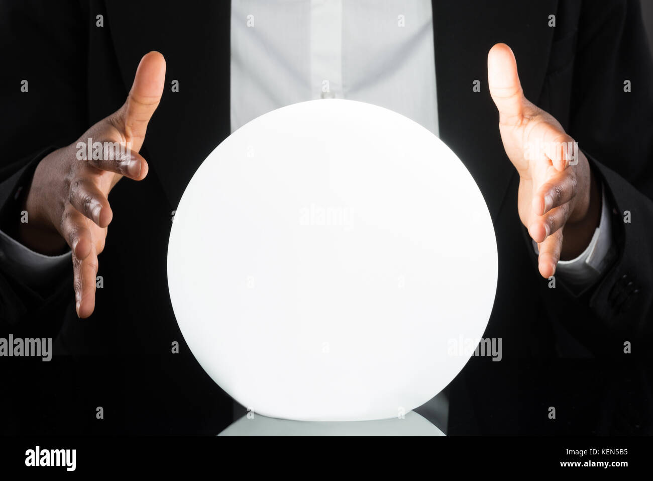 Close-up Of Businessperson Predicting Future With Crystal Ball On Desk ...