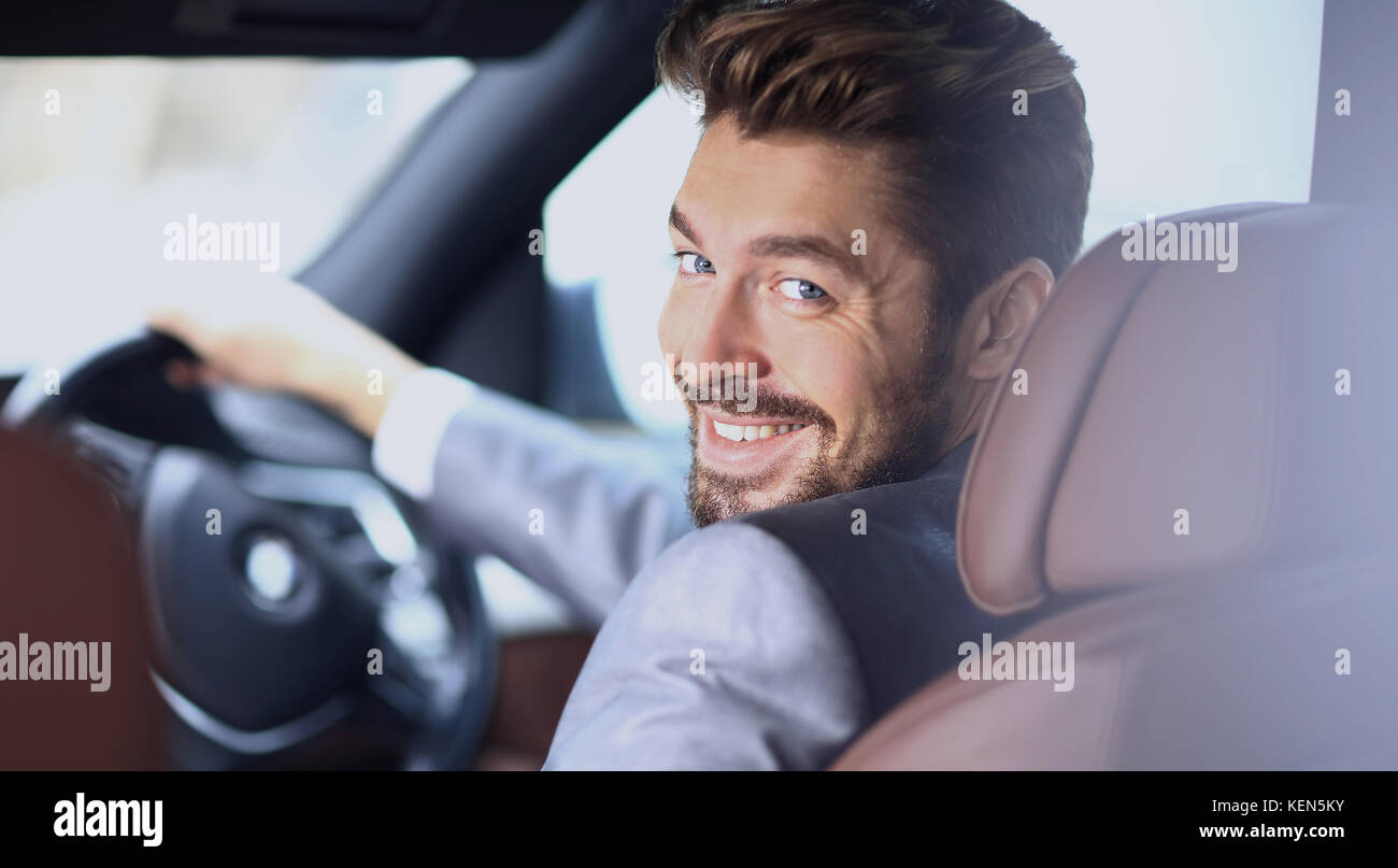 Portrait of an handsome smiling business man driving his car Stock ...