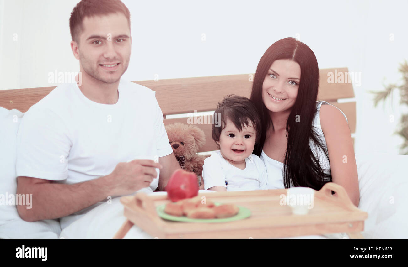 Smiling family having breakfast Stock Photo - Alamy