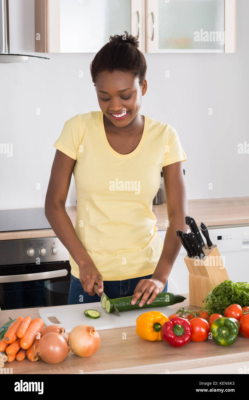 Close-up Of Woman's Hand Chopping Vegetables With Knife In Kitchen Stock  Photo, Picture and Royalty Free Image. Image 56706435.