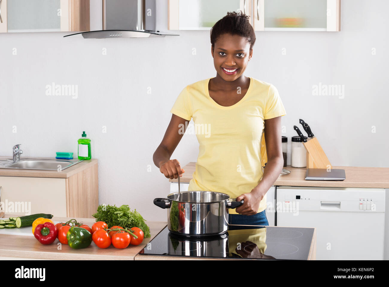 Woman cooking kitchen black hi-res stock photography and images