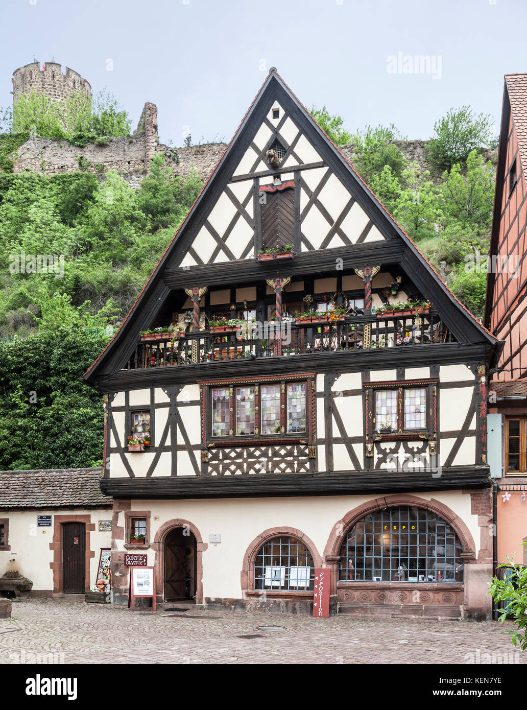 A painted and embellished medieval halftimbered building, now a allery