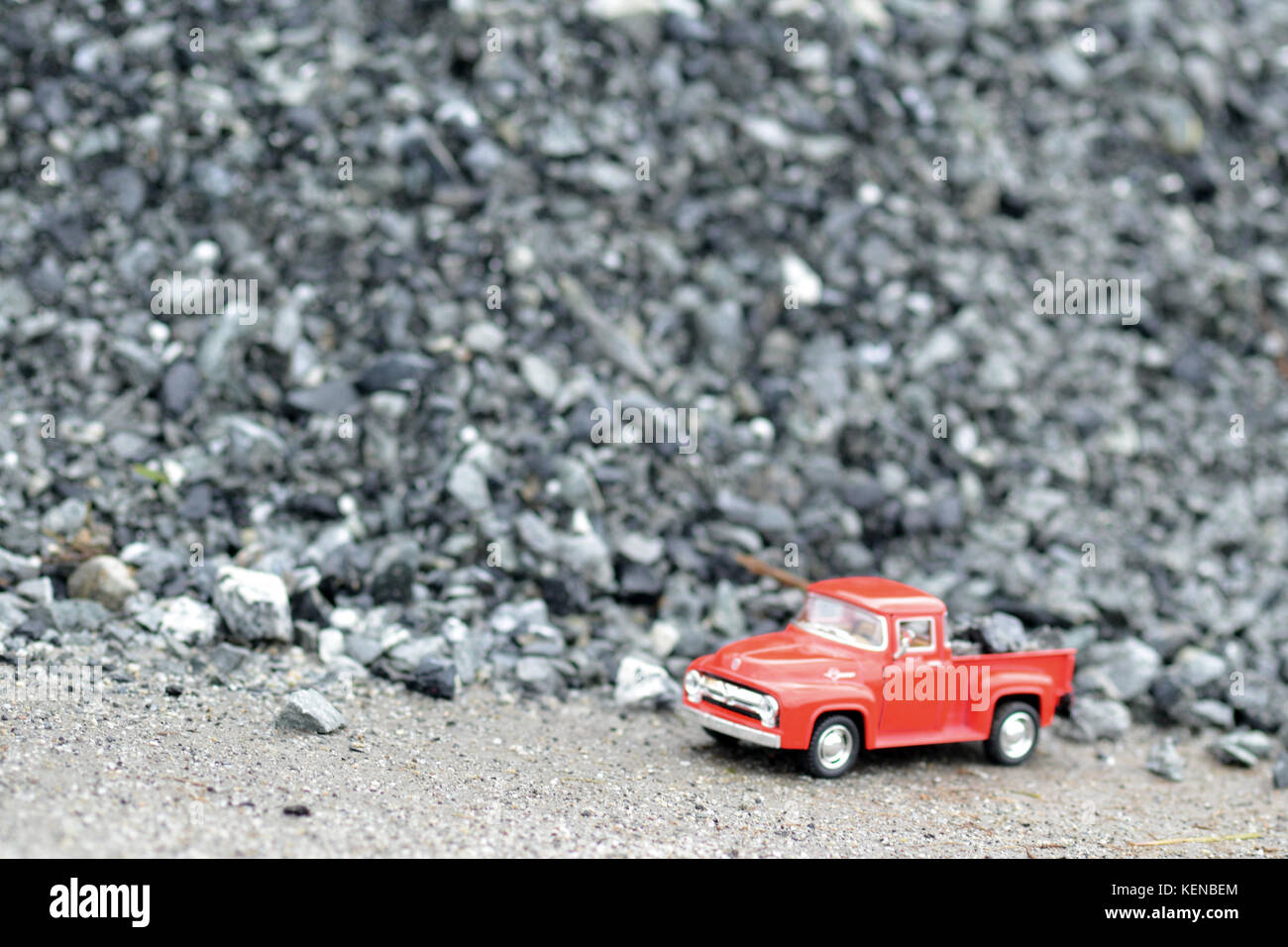 Little Truck, Big Job.  Toy truck beside a pile of gravel, taken with my macro lens Stock Photo