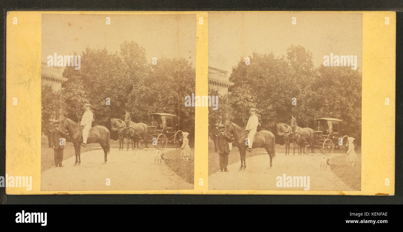 View of African American groom holding reins of horse with rider, from Robert N. Dennis collection of stereoscopic views 2 Stock Photo