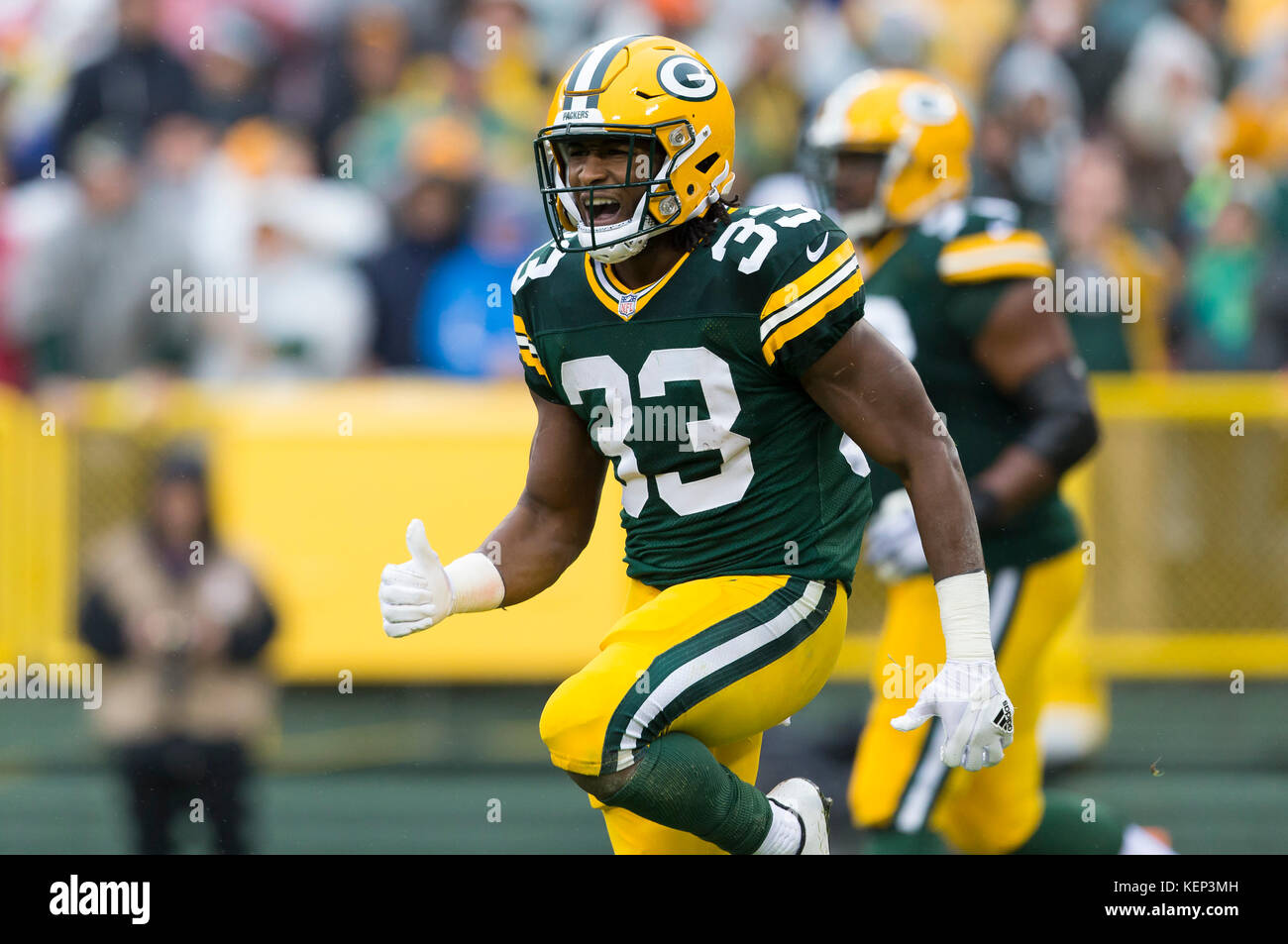 Green Bay Packers running back Aaron Jones (33) runs in front of San  Francisco 49ers cornerback Richard Sherman (25) and strong safety Jaquiski  Tartt (29) during the NFL football NFC Championship game