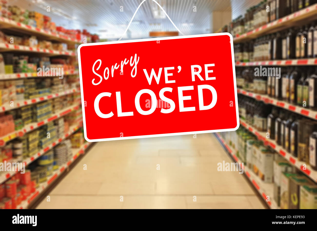 Sorry we are closed label on a blur Supermarket background Stock Photo